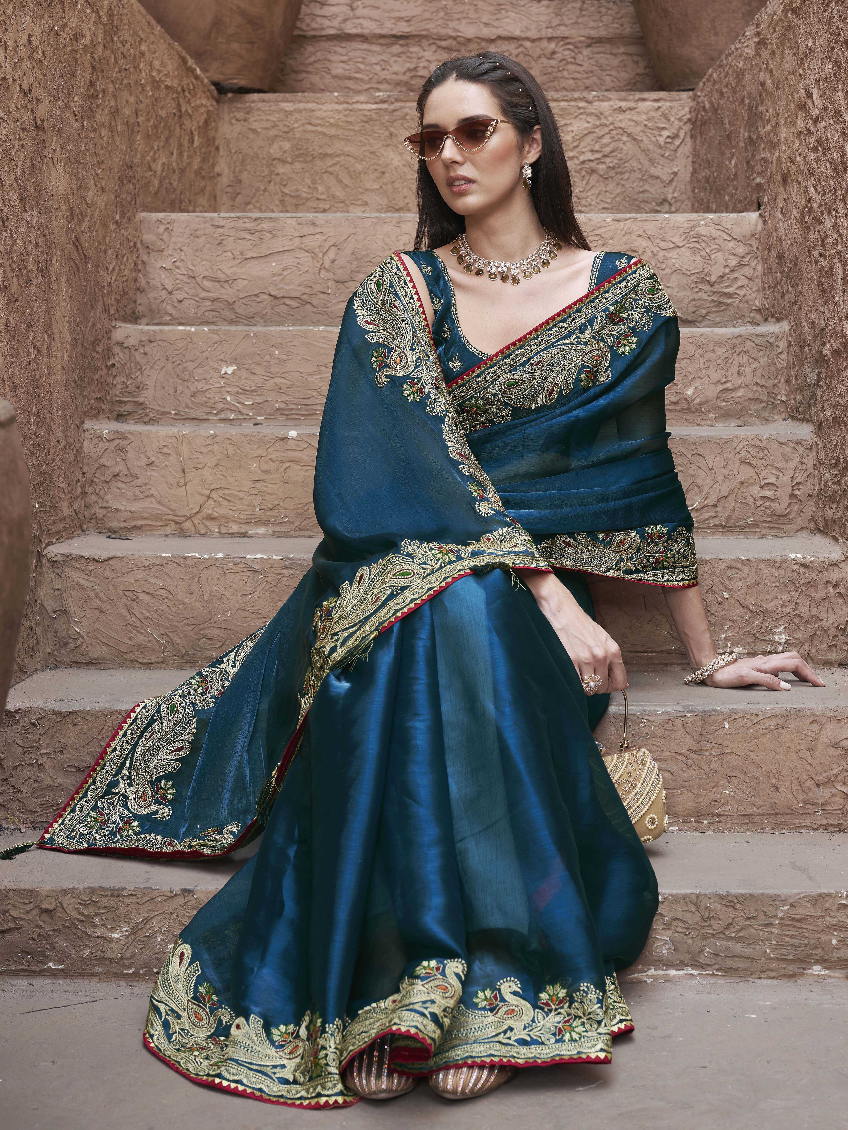Teal colored zari embroidered saree